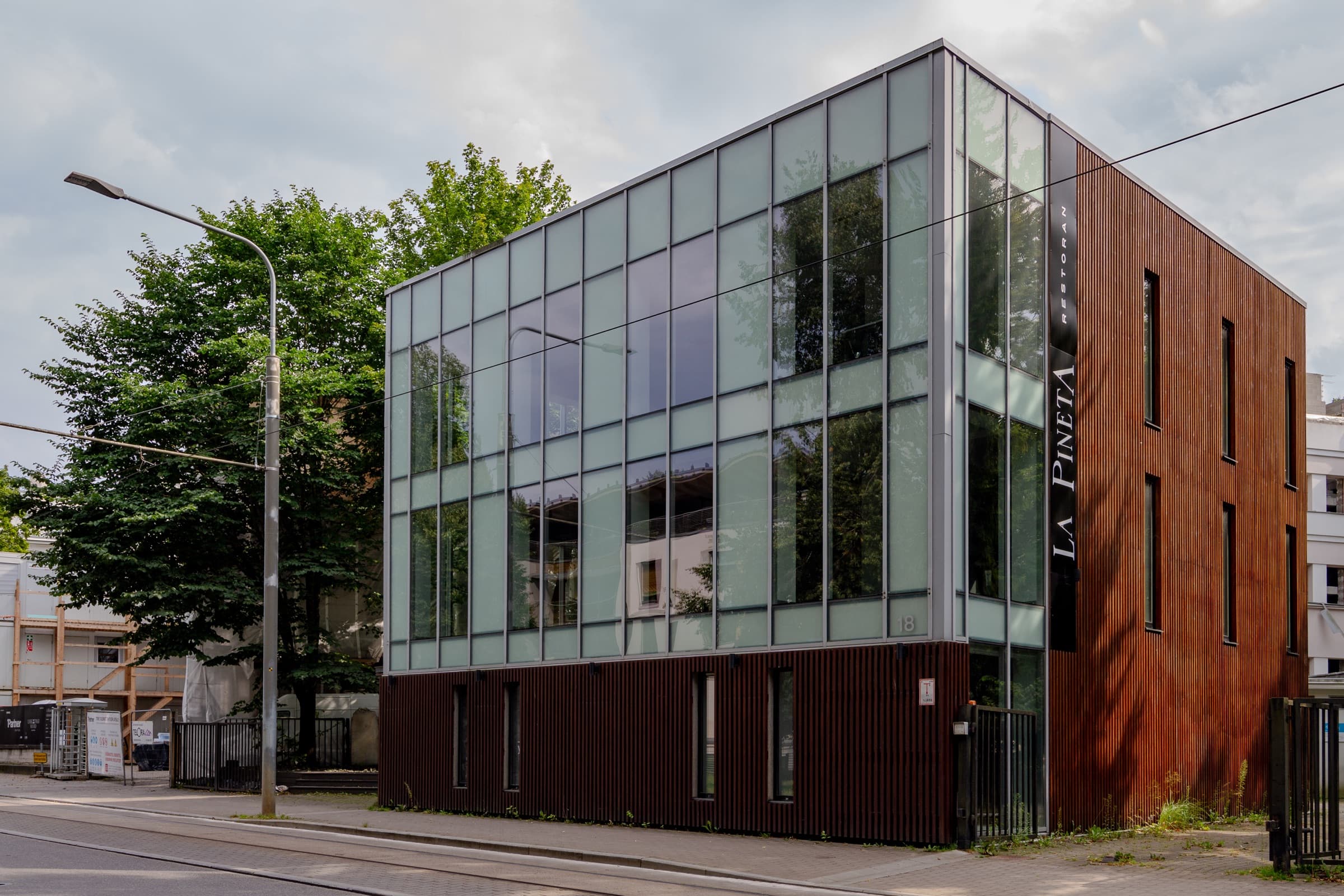 Corner elevation — glass and weathering steel